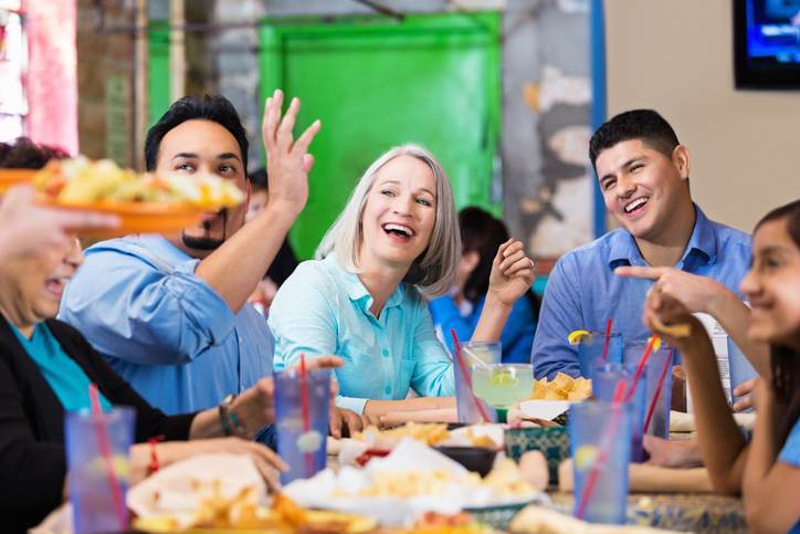 Group of friends enjoying dinner together in casual restaurant